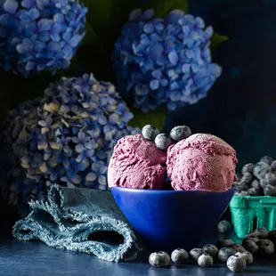 three scoops of ice cream in a blue bowl