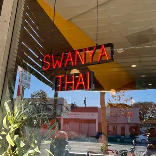 a neon sign in the window