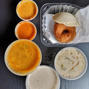 Upma (semolina with spices and veggies), idli ( rice cake), medu vada (fried lentil donut) with sauces and lentil soup