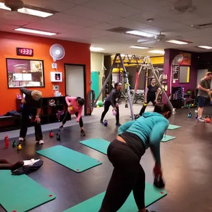 6am Kettlebell class performing a bent over row move.