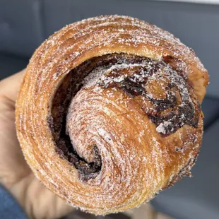 a person holding a pastry in their hand