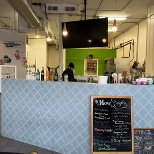 a woman behind the counter of a cafe