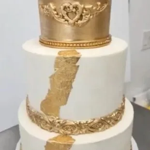 a white and gold wedding cake