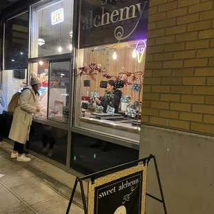 a woman standing outside of a store