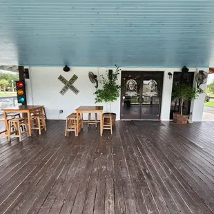 a porch with tables and chairs