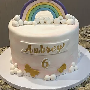 a birthday cake with a rainbow