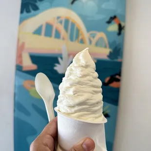 a hand holding an ice cream cone