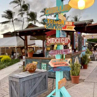 a sign post with a variety of signs on it