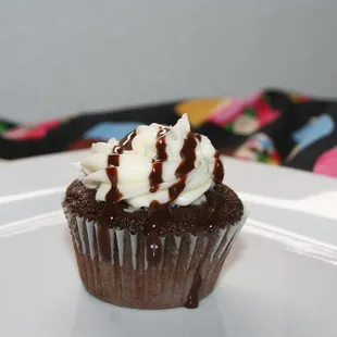 a chocolate cupcake on a white plate