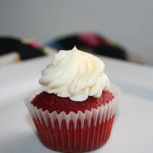 a red velvet cupcake with white frosting
