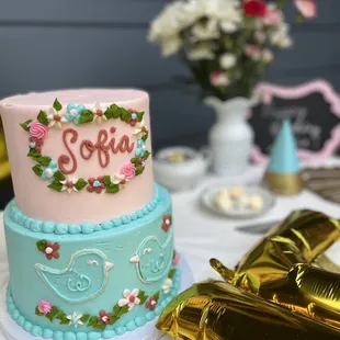 a pink and blue cake on a table