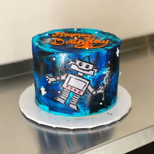 a birthday cake with a robot on it