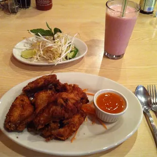 Chicken wings and hot/sweet sauce and Strawberry Bubble Tea.
