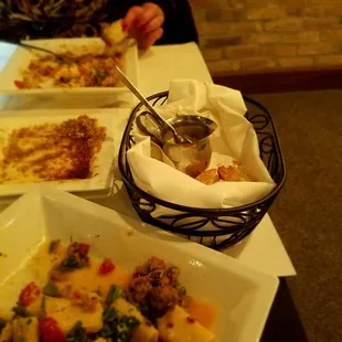 a woman sitting at a table with plates of food