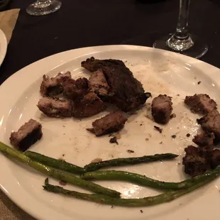 a plate of meat and asparagus