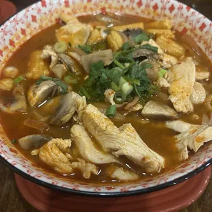 Tom Yum Soup with chicken and glass noodles.