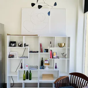 a kitchen with a refrigerator and shelves