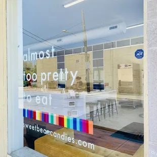 a storefront window with a sign that says almost too pretty to eat