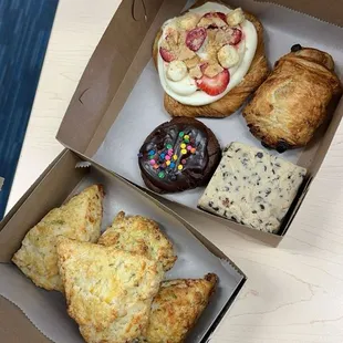 Bacon cheddar scallion scones, cosmic brownie cookie, chocolate chip cookie dough brownie, chocolate croissant, strawberry cheesecake snail.