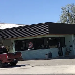 a red truck parked in front of a store