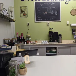 a kitchen counter with a chalkboard on the wall