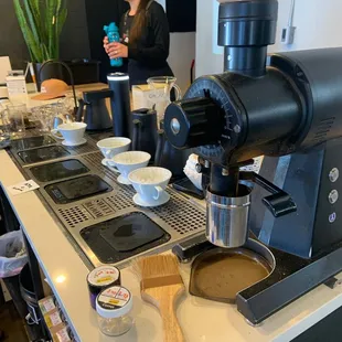 a woman preparing a cup of coffee