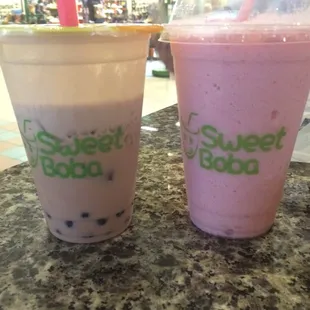 Strawberry milk tea with boba and a strawberry smoothie.