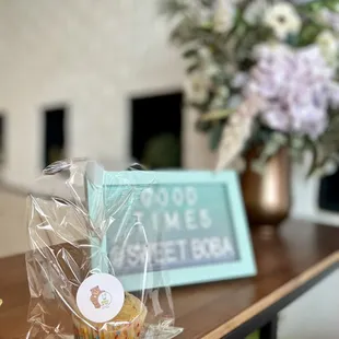 a cupcake and a good times sign on a table