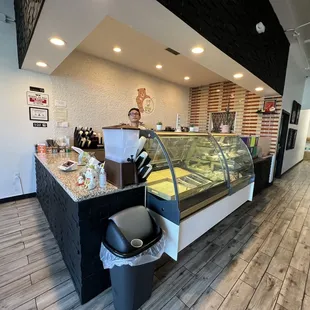 Ordering counter with display case of cakes &amp; cookies