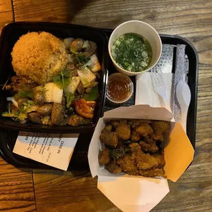 a tray of fried chicken and a bowl of dipping sauce