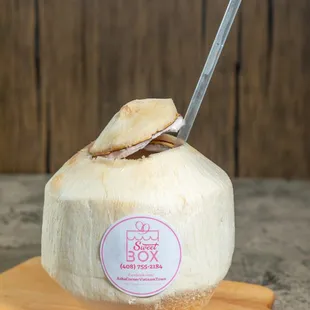 the inside of a coconut with a spoon sticking out of it