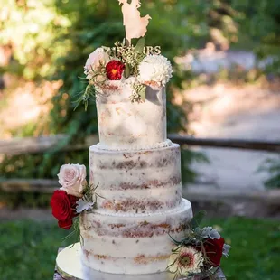 a wedding cake with a bird topper