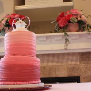 a pink cake with flowers on top