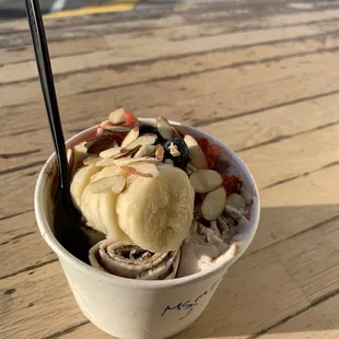 an ice cream sundae with fruit and nuts