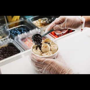 a person holding a bowl of ice cream