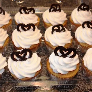 a dozen cupcakes with white frosting