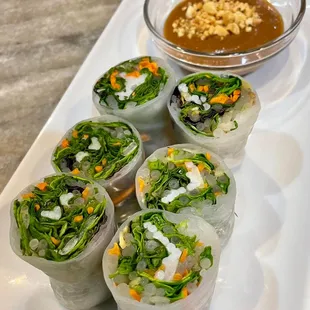 a plate of rolls with dipping sauce