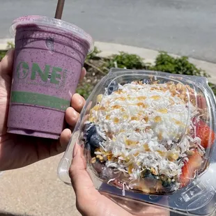 a hand holding a purple smoothie