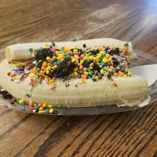Banana split with vanilla and strawberry ice cream, needs, sprinkles and oreos