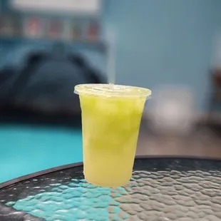 a glass of lemonade on a table