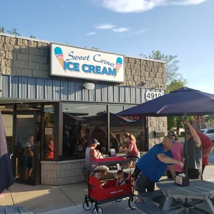 people sitting at picnic tables