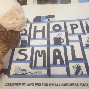 a hand holding a cone of ice cream