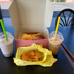 a cup of coffee and a box of doughnuts