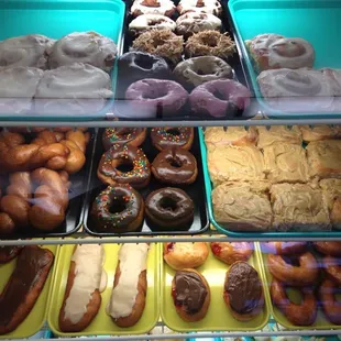 a variety of doughnuts in a display case