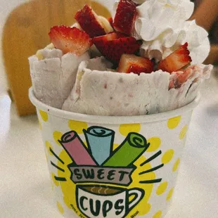  cup of ice cream with strawberries and whipped cream