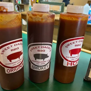 three bottles of barbecue sauce
