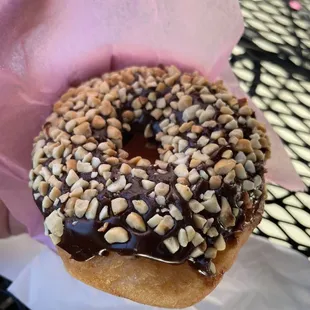 a donut covered in chocolate and nuts