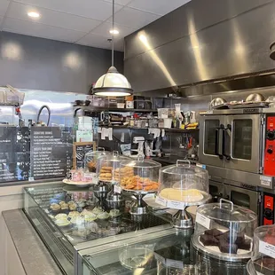 a bakery counter with a variety of baked goods