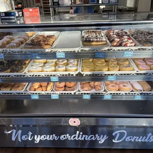 a variety of donuts in a display case