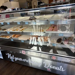 a display case with a variety of donuts